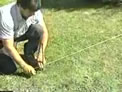 Using a string to mark the location of the front of the wall.